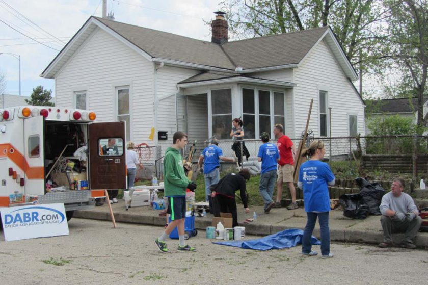 a group of people cleaning a neighborhood